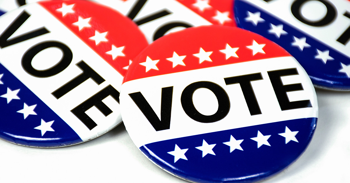 A collection of red, white, and blue vote buttons.