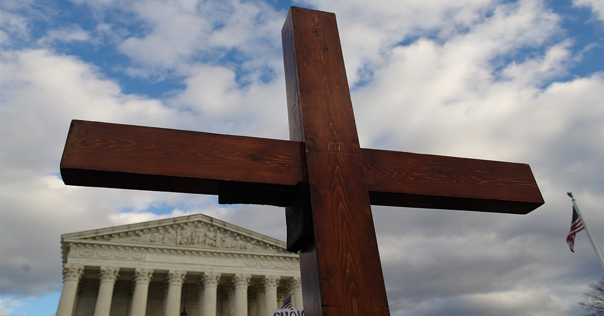 A cross stands in front of the U.S. Supreme Court.