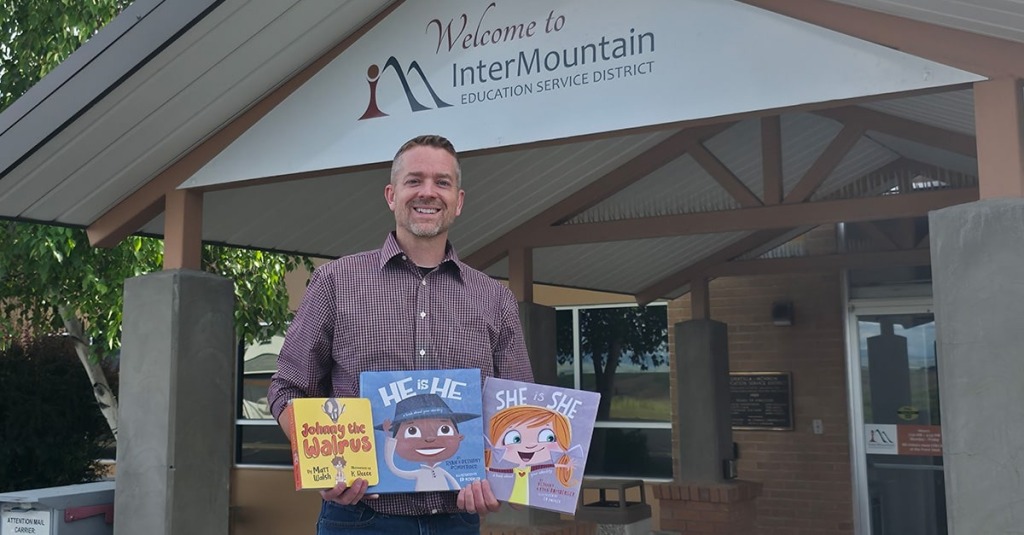 Christian social worker holds "Johnny the Walrus," "He is He," and "She is She," the three books Oregon education officials told him he couldn't display in his office.